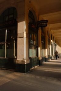 Home Sunlit corridor of Paris' Palais Royal highlighting classic architecture.